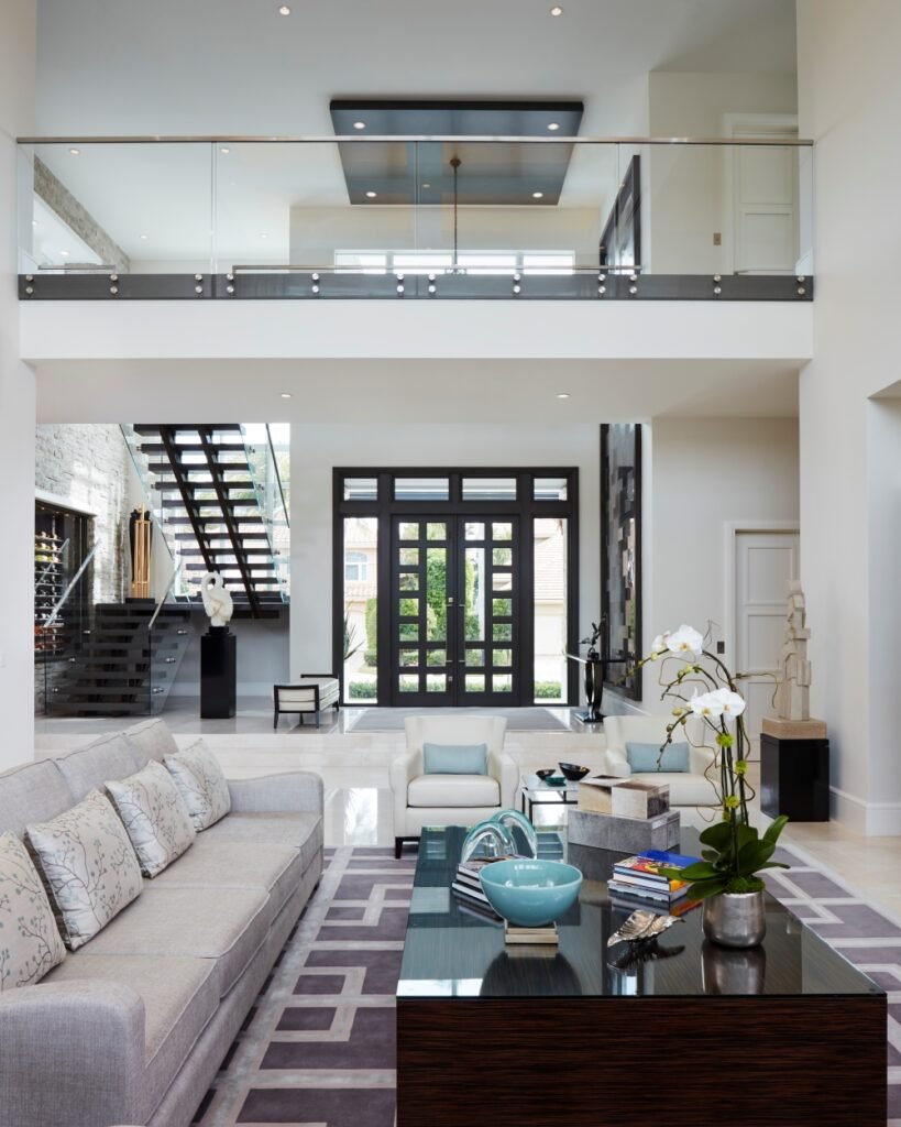 Interior designer reviewing floor plans and material samples at luxury South Florida home design consultation meeting