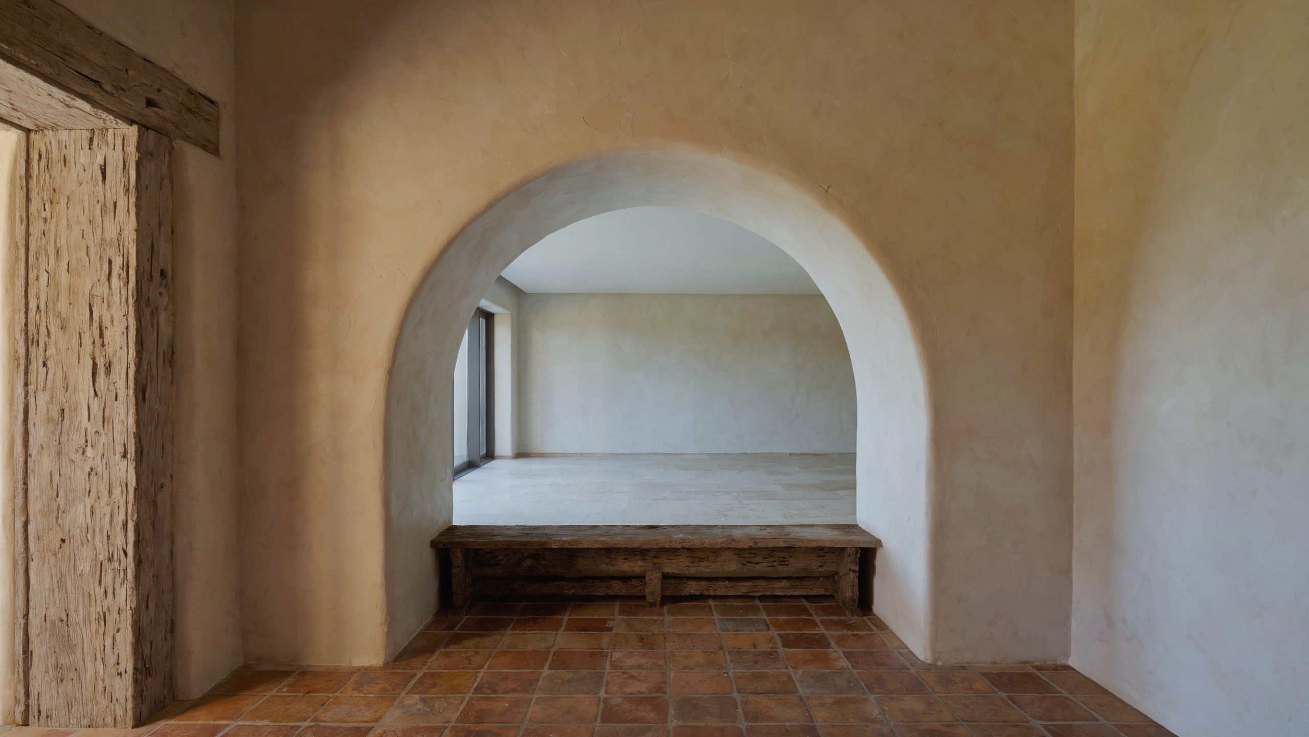 Boca Raton interior design showing a Mizner arched loggia opening into a contemporary great room